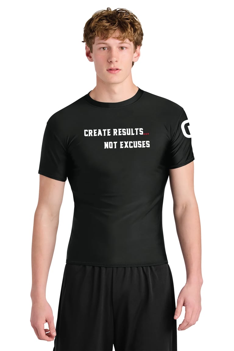 Young man wearing black shirt with Create Results Not Excuses text, standing against white background
